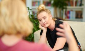 psychotherapist talking to female patient