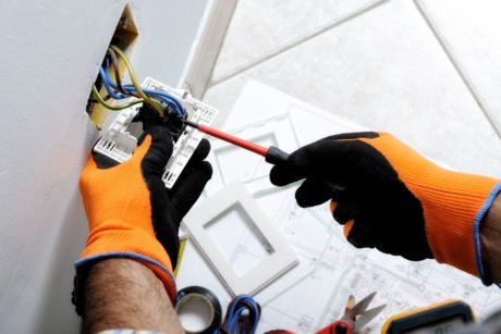 electrician fixing a wall plug