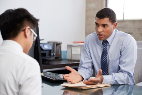 professional ptsd counselor talking to male patient