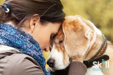 woman hugging dog