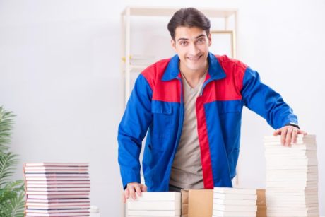 author with stacks of books