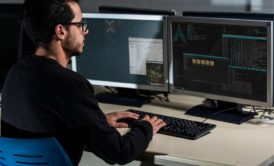 man typing on desktop computer