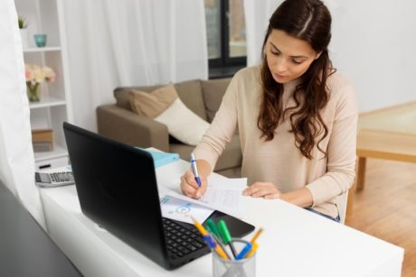 woman writing on paper