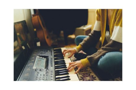 composer playing electric organ