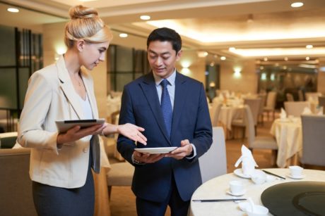 A woman in business attire, aspiring to become an event planner, engaged in a discussion about plans for an event