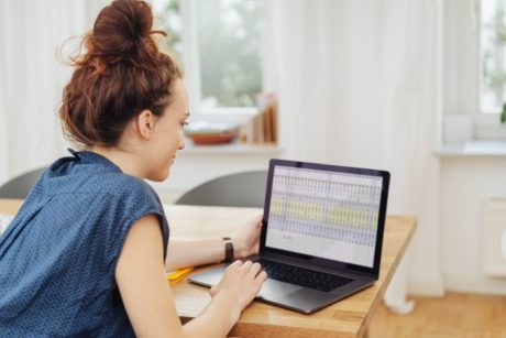 woman using excel on black laptop