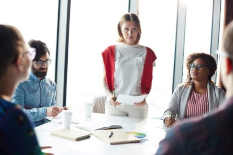 a woman presenting to a group on how to be a life coach