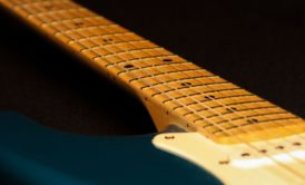 blue guitar with guitar fretboard