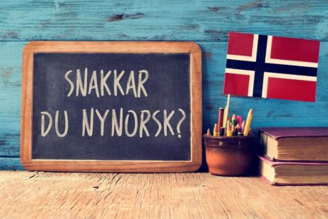 norwegian flag and greeting written on blackboard