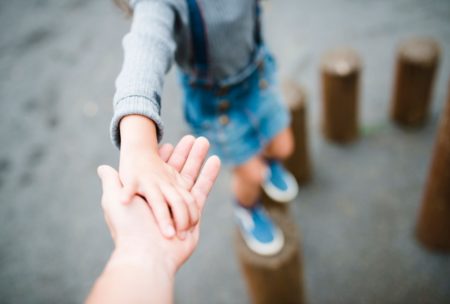 father holding son's hand