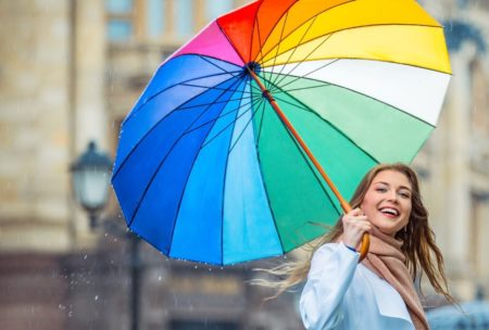 woman holding colorful umbrella