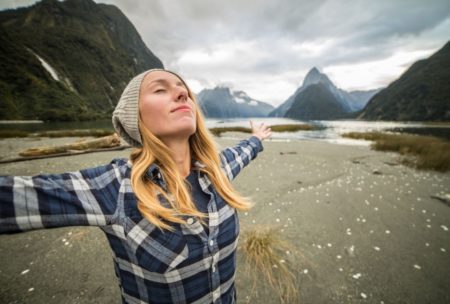 woman spreading hands looking up the sky