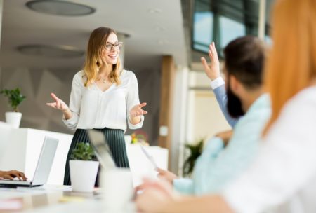 woman presenting to team