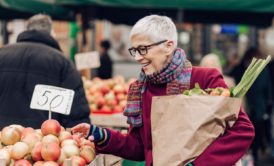 old woman shopping for apples