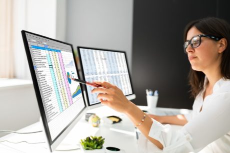 woman working with power BI on desktop computer