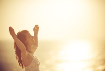 happy woman raising her hands