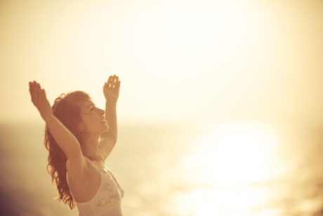 happy woman raising her hands