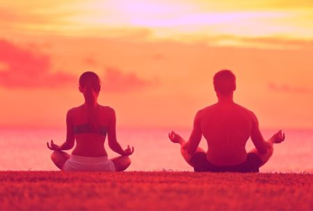 man and woman meditating