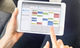 person using time management app on tablet device