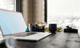 silver laptop final cut pro x on wooden desk