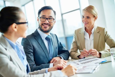 three colleagues communicating effectively in the workplace