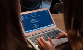 two women working with primavera p6 on silver laptop