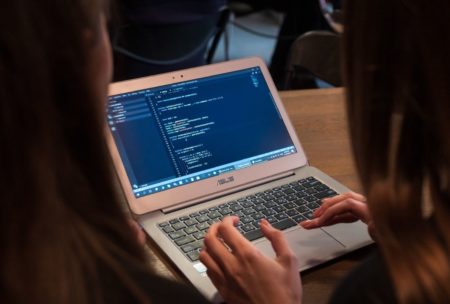 two women working with primavera p6 on silver laptop