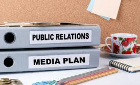 binders with labels public relations and media plan