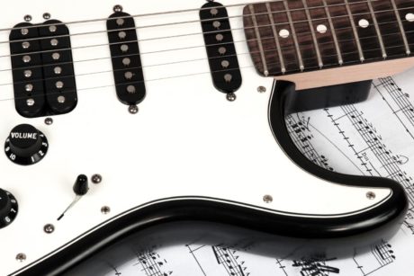 close up of a white electronic guitar