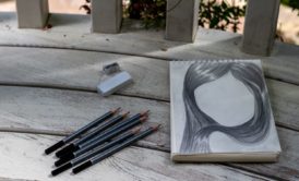 pencil portrait of a woman on a white sketchbook