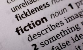 close up of the word fiction in the dictionary