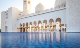 pool outside a white arabic temple