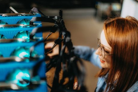 woman setting up pc for cryptocurrency mining