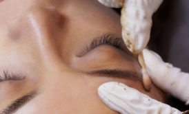 brow lamination being performed on woman's face