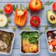 trays of healthy food arranged on top of gray wooden table