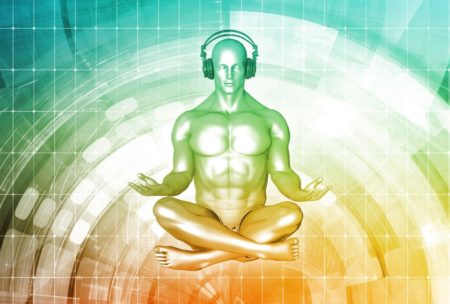 man sitting down meditating and listening to music