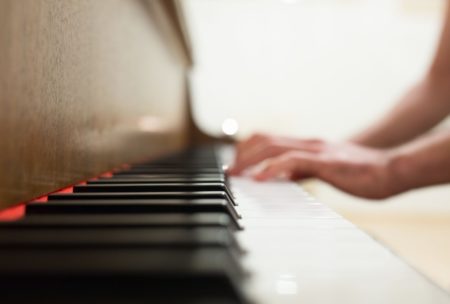 close up of person playing the piano