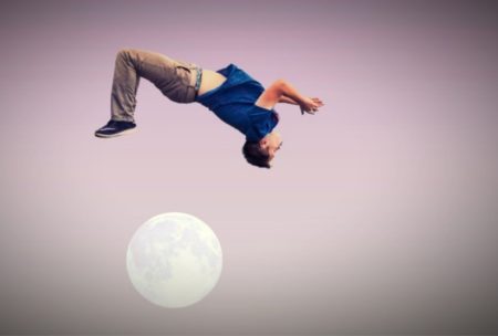 male gymnast jumping over the moon