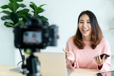 woman in pink top recording an online course