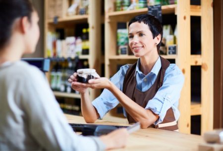 salesperson selling product to female customer