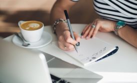 sales person writing script on notepad