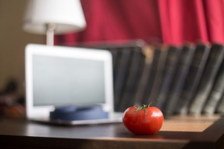 white laptop books and tomato