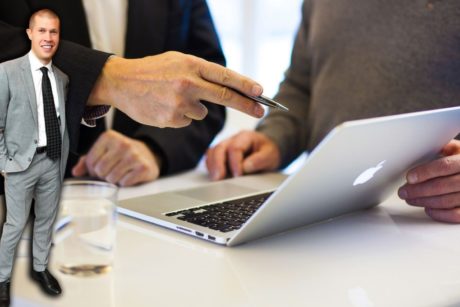 business consultant talking to client pointing at silver laptop