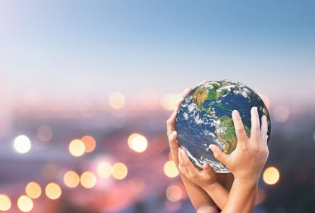 person holding globe in hands