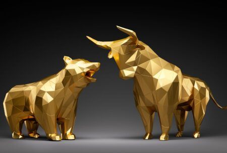 a gold bull and bear on a black background, illustrating the concept of defensive stock investing