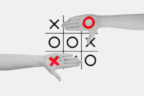 hands displaying a tic tac toe board designed with a python theme