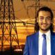 A man in a suit and tie stands before electricity pylons, conducting fault analysis.