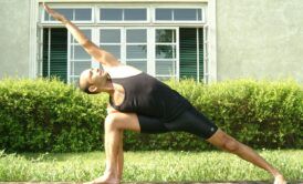 A man practicing a yoga pose outdoors, promoting yoga for busy people seeking relaxation and balance.