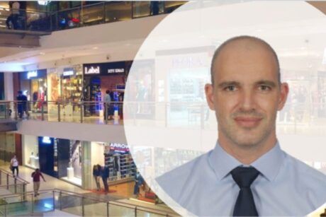 Professional man in tie and shirt at a mall. LEED Green Associate Exam.