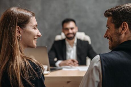 a man and woman having a conversation in an office, illustrating nonverbal cues for how to read people